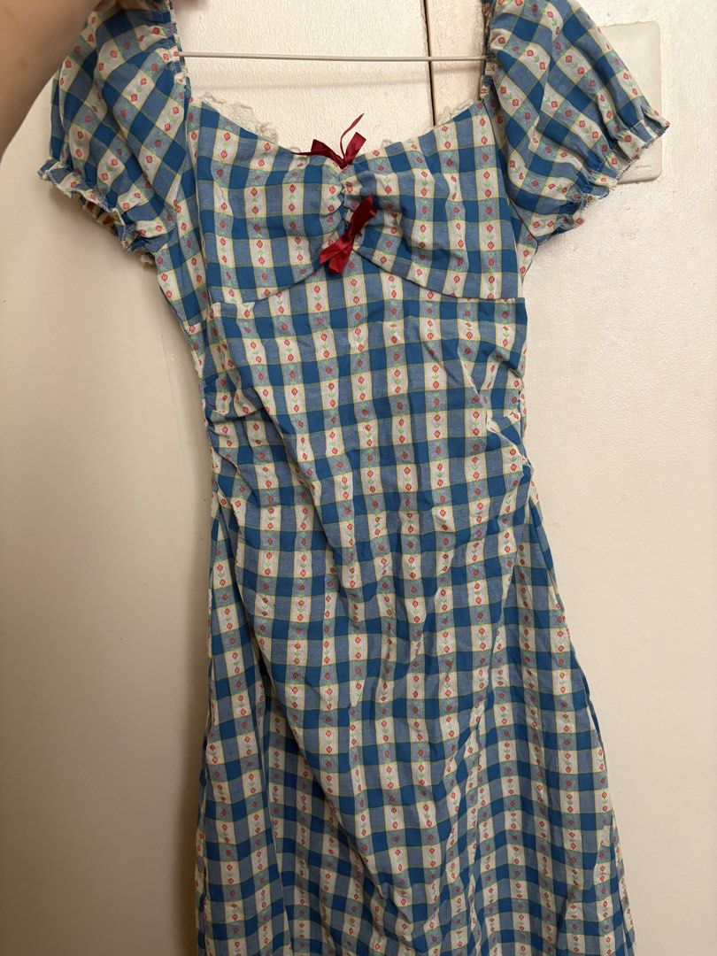 Blue Gingham Puff Sleeve Dress with Red Bow (Category: Dresses) located in Manila. Submitted by z.finds (Listing ID 1460371822, Image 2). Description: - Adorable blue gingham dress - Sweetheart neckline - Puff sleeves with a small red bow detail - Shirring on the sides for a flattering, adjustable fit - Zipper closure at the back - Perfect for picnics, casual outings, or a cute day out.