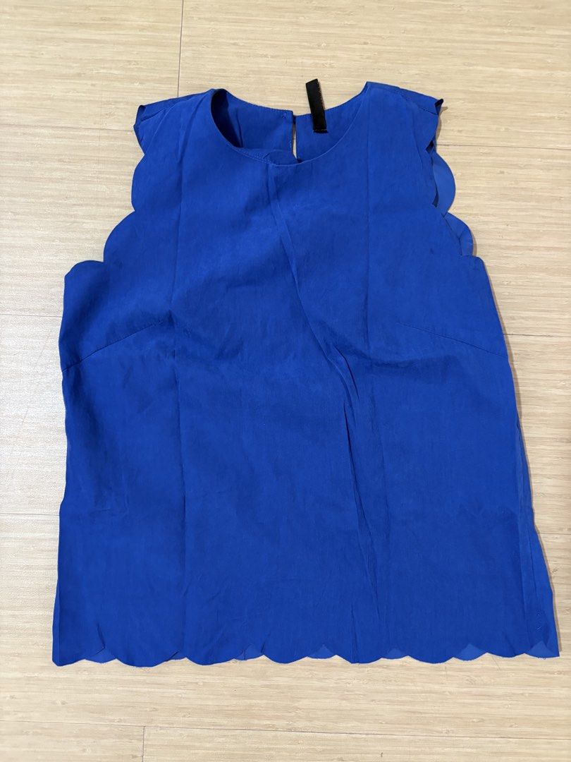 Blue Scalloped Hem Sleeveless Top (Category: Sleeveless) located in Taguig. Submitted by secondhandstuffhere (Listing ID 1460316533, Image 1). Description: - Bright blue sleeveless top - Features a cute scalloped hemline - Cap sleeves - Keyhole closure at the back - Light and flowy material - Versatile for dressing up or down.