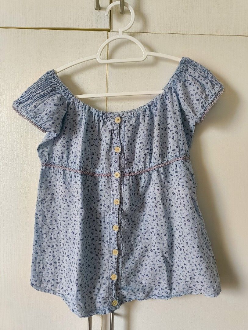 XS to S Blue Tops Bundle (Category: Blouses) located in Pasig City. Submitted by gaosorio17 (Listing ID 1460395968, Image 2). Description: - Both tops are thrifted but they don't fit me well - Both fit XS to S - No when worn for these Top 1: - Floral light blue milkmaid style top - Garterized puff sleeves - Working and complete buttons - Can be worn as an off shoulder top Top 2: - Denim-like sleeveless top - With ruffle detail and purple contrast