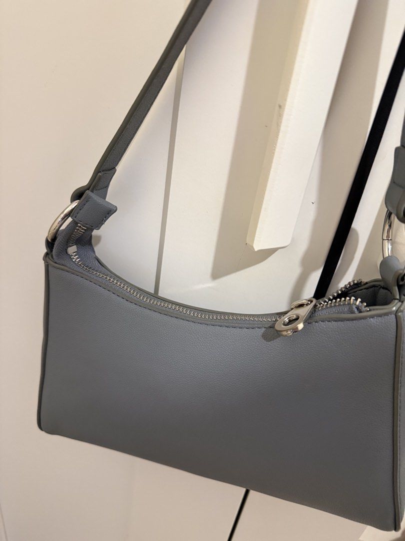 Blue-Grey Shoulder Bag with Zipper Closure (Category: Shoulder Bags) located in Manila. Submitted by cooldragon_2d8241 (Listing ID 1460402994, Image 2). Description: - Grey shoulder bag - Zipper closure - Silver hardware details on strap - Simple and classic design - Ideal for everyday use - Fits your essentials.