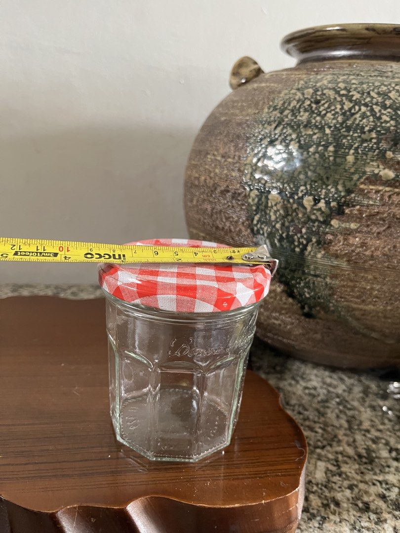 Bonne Maman Jam Jar with Gingham Lid (Category: Food Organization & Storage) located in Taguig. Submitted by minmin_parker (Listing ID 1460365209, Image 3). Description: - Adorable Bonne Maman jam jar - Classic hexagonal shape - Features a red and white gingham lid - Ideal for storing small items, crafts, or as a decorative accent - Clean and ready for its next home.