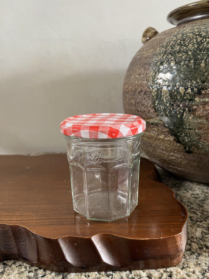 Bonne Maman Jam Jar with Gingham Lid (Category: Food Organization & Storage) located in Taguig. Submitted by minmin_parker (Listing ID 1460365209, Image 1). Description: - Adorable Bonne Maman jam jar - Classic hexagonal shape - Features a red and white gingham lid - Ideal for storing small items, crafts, or as a decorative accent - Clean and ready for its next home.