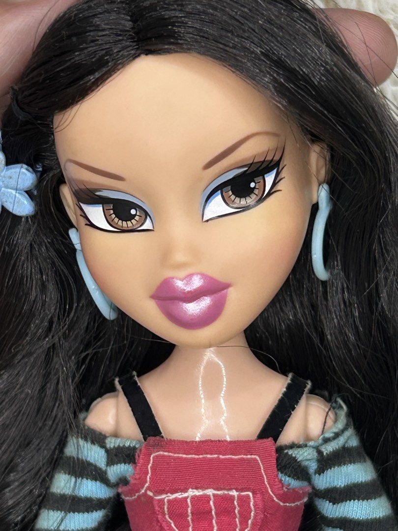 Bratz p4f artist jade (Category: Kids Toys) located in Manila. Submitted by buri_cat (Listing ID 1460319652, Image 3). Description: - Bratz doll with long, wavy black hair. - Outfit: Striped sleeves, red top, patterned skirt, black leggings. - Footwear: Black boots. - Accessories: Blue hoop earrings, blue flower in hair. - Ready for a new home!.