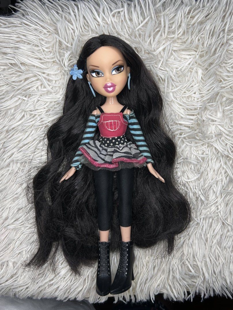 Bratz p4f artist jade (Category: Kids Toys) located in Manila. Submitted by buri_cat (Listing ID 1460319652, Image 1). Description: - Bratz doll with long, wavy black hair. - Outfit: Striped sleeves, red top, patterned skirt, black leggings. - Footwear: Black boots. - Accessories: Blue hoop earrings, blue flower in hair. - Ready for a new home!.