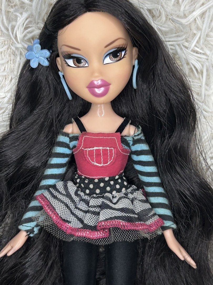 Bratz p4f artist jade (Category: Kids Toys) located in Manila. Submitted by buri_cat (Listing ID 1460319652, Image 2). Description: - Bratz doll with long, wavy black hair. - Outfit: Striped sleeves, red top, patterned skirt, black leggings. - Footwear: Black boots. - Accessories: Blue hoop earrings, blue flower in hair. - Ready for a new home!.
