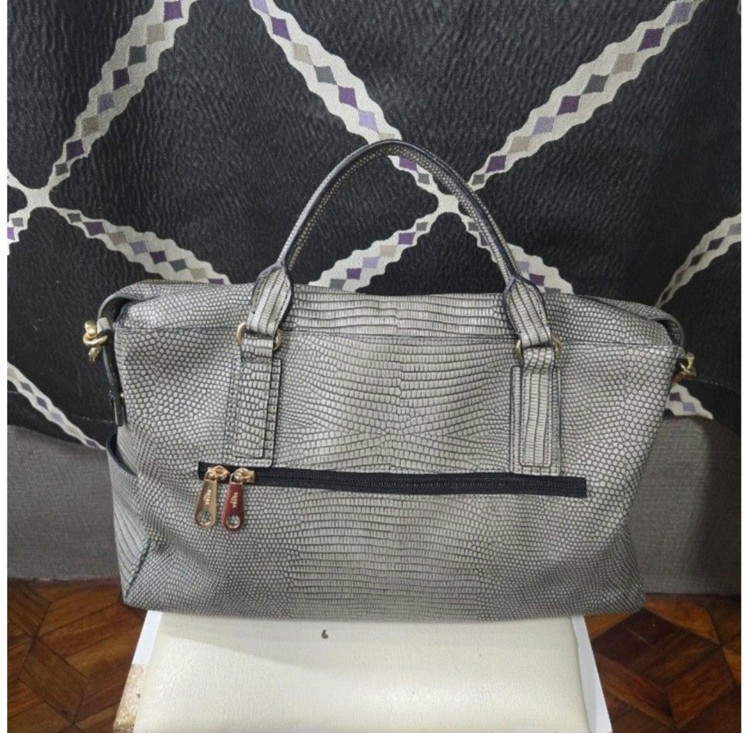 Brera Leather Satchel Handbag (Category: Other Accessories) located in Quezon City. Submitted by affordabags_cd (Listing ID 1460426829, Image 2). Description: - SERRA Italy grey embossed leather satchel bag - Textured finish with gold-tone hardware - Top handles and detachable shoulder strap - Exterior zip pocket - Interior zip pocket and card slots - Approximate measurements: 14" wide, 9" tall, 6" deep.