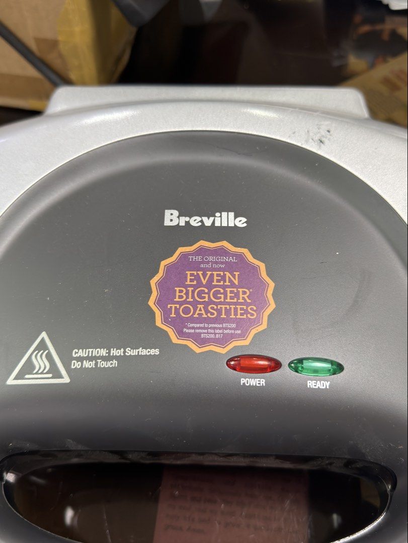Breville The Big One Sandwich Maker (Category: Ovens & Toasters) located in Pasay City. Submitted by meostore (Listing ID 1460385878, Image 2). Description: Key FeaturesDesign: Silver and grey plastic body with a locking latch on the handle. Capacity: Deep non-stick cooking plates made to fit extra fillings and larger bread slices.Indicator Lights: Red power light and green ready light on the top lid. Power: Runs on 1000 watts to toast sandwiches