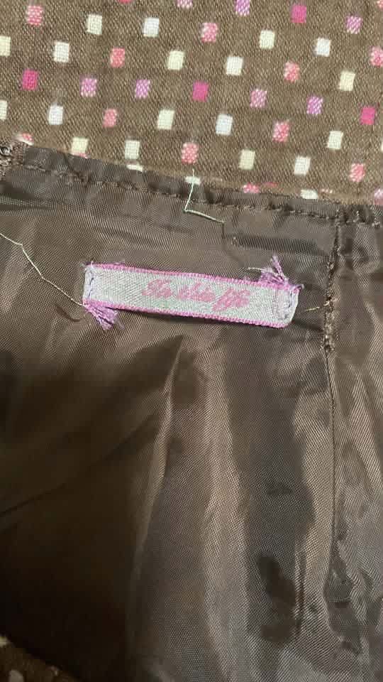 Brown A-line Skirt with Geometric Pattern (Category: Skirts) located in Manila. Submitted by airamef28.closet (Listing ID 1460420505, Image 2). Description: - Midi length A-line skirt - Features a small geometric pattern in white, pink, and maroon - Estimated size 26-27 (check tag for exact measurements) - Smooth inner lining for comfort - Versatile for casual or dressed-up looks.