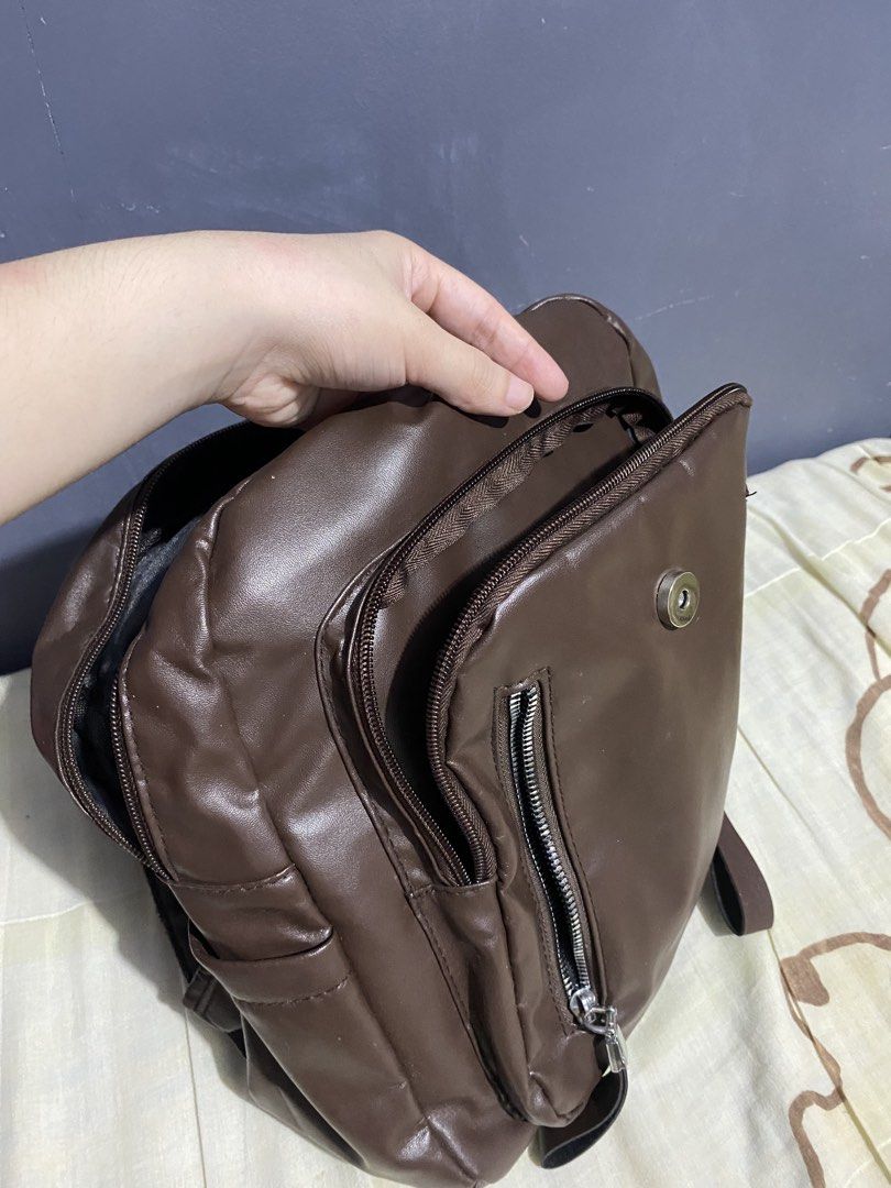 Brown Faux Leather Backpack with Multiple Zippers (Category: Backpacks) located in Carmona. Submitted by chelat_ (Listing ID 1460415016, Image 2). Description: - Chic brown faux leather backpack - Spacious main compartment with an inner zip pocket - Convenient front zip pockets (two) - Handy side pockets - Secure magnetic snap closure under a flap - Adjustable straps for a comfortable fit - Ideal for everyday adventures.