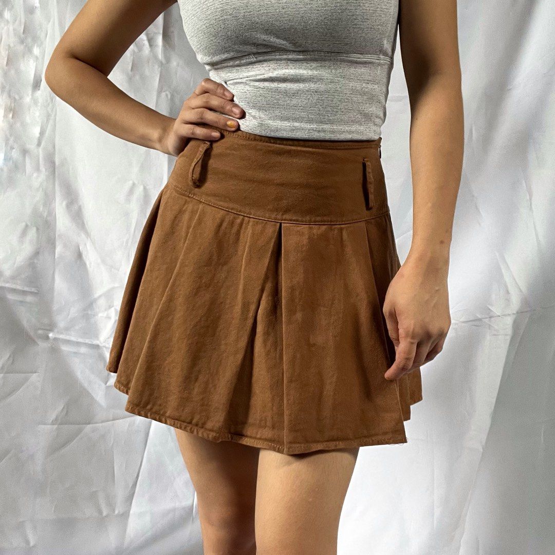 Brown Pleated Mini Skirt with Shorts Underlay (Category: Skirts) located in Manila. Submitted by demi.rewears (Listing ID 1460314210, Image 3). Description: Cute brown pleated mini skirt with built-in shorts. Soft suede/corduroy-like fabric with unique button detail. Perfect for casual or dressed-up looks! Size: Fits Extra Small (XS) Waist: Fits 22” to 24” (11.5” flat lay) Length: 14” (Micro mini length).