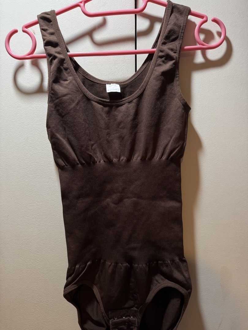 Brown Seamless Shapewear Bodysuit M/L (Category: Undergarments & Loungewear) located in Manila. Submitted by baddxss (Listing ID 1460386556, Image 1). Description: - Seamless brown bodysuit for a smooth silhouette. - Provides shaping and smoothing effect. - Adjustable hook-and-eye closure at the crotch for convenience. - Comfortable for all-day wear. - Crafted from a blend of polyamide and elastane. .