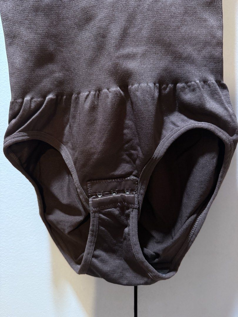 Brown Seamless Shapewear Bodysuit M/L (Category: Undergarments & Loungewear) located in Manila. Submitted by baddxss (Listing ID 1460386556, Image 3). Description: - Seamless brown bodysuit for a smooth silhouette. - Provides shaping and smoothing effect. - Adjustable hook-and-eye closure at the crotch for convenience. - Comfortable for all-day wear. - Crafted from a blend of polyamide and elastane. .