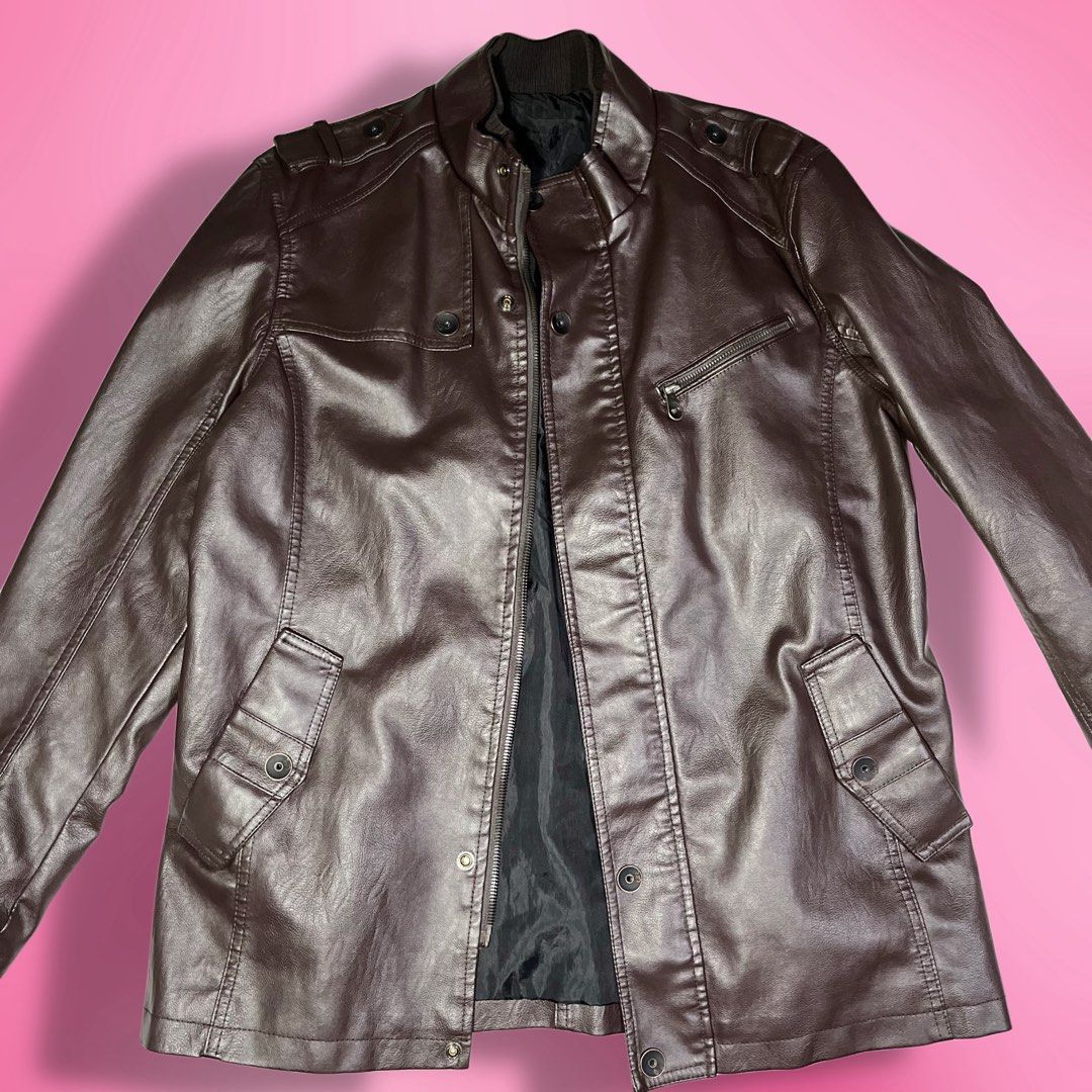 Brown Unisex Faux Leather Jacket (Category: Coats, Jackets and Outerwear) located in Quezon City. Submitted by ayzria (Listing ID 1460451042, Image 1). Description: 🎀 brown faux leather jacket a timeless little staple for your next fit ♡ ♡ fits m-l / oversized fit ♡ bust: 44” ♡ shoulder: 18” ♡ sleeve length: 25” ♡ length: 28” ♡ waist: 40” ♡ thick & heavy material ♡ good condition ♡ front pockets + zipper closure.