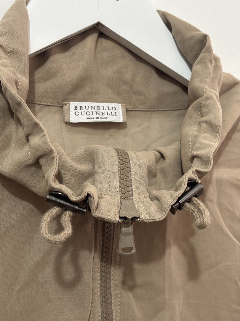 Brunello Cucinelli (Category: Coats, Jackets and Outerwear) located in Manila. Submitted by kingblaize (Listing ID 1460492834, Image 3). Description: beige Brunello Cucinelli lightweight zip-up jacket featuring dark contrast piping along the shoulders and sleeves..