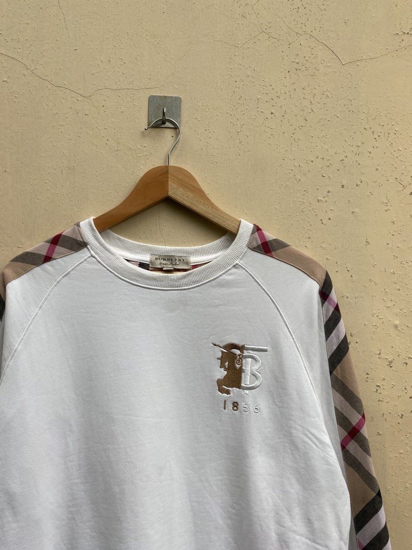 Burberry Sweatshirt (Category: Coats, Jackets and Outerwear) located in Manila. Submitted by swordthrift (Listing ID 1460420855, Image 2). Description: - Burberry Sweatshirt - Dimes: 22x25 - Size: Medium (M) - Iconic Burberry check pattern on sleeves - Small embroidered logo and ‘1856’ detail on front - Made in China - Ideal for casual wear.