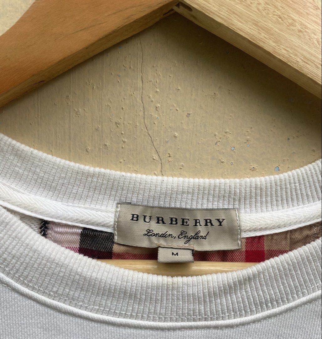 Burberry Sweatshirt (Category: Coats, Jackets and Outerwear) located in Manila. Submitted by swordthrift (Listing ID 1460420855, Image 3). Description: - Burberry Sweatshirt - Dimes: 22x25 - Size: Medium (M) - Iconic Burberry check pattern on sleeves - Small embroidered logo and ‘1856’ detail on front - Made in China - Ideal for casual wear.