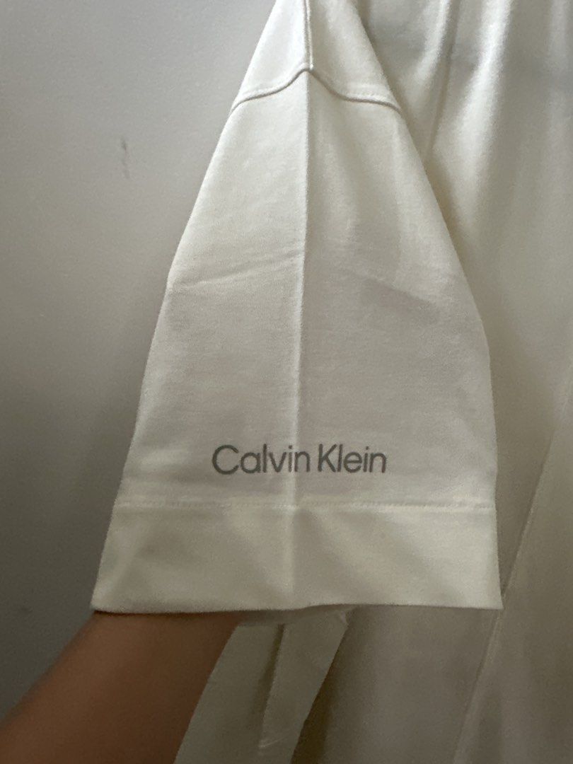 Calvin Klein Cream T-shirt (Category: Tshirts & Polo Shirts ) located in Mandaluyong City. Submitted by ayesesey (Listing ID 1460407040, Image 3). Description: - Cream Calvin Klein T-shirt - Size: Large (L) - Features Calvin Klein logo printed on the sleeve - Made in Sri Lanka - Simple and classic design - Ideal for everyday wear - With stain due to storage in the closet, but never been used.