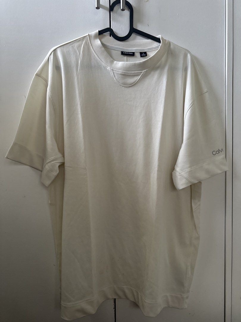 Calvin Klein Cream T-shirt (Category: Tshirts & Polo Shirts ) located in Mandaluyong City. Submitted by ayesesey (Listing ID 1460407040, Image 1). Description: - Cream Calvin Klein T-shirt - Size: Large (L) - Features Calvin Klein logo printed on the sleeve - Made in Sri Lanka - Simple and classic design - Ideal for everyday wear - With stain due to storage in the closet, but never been used.