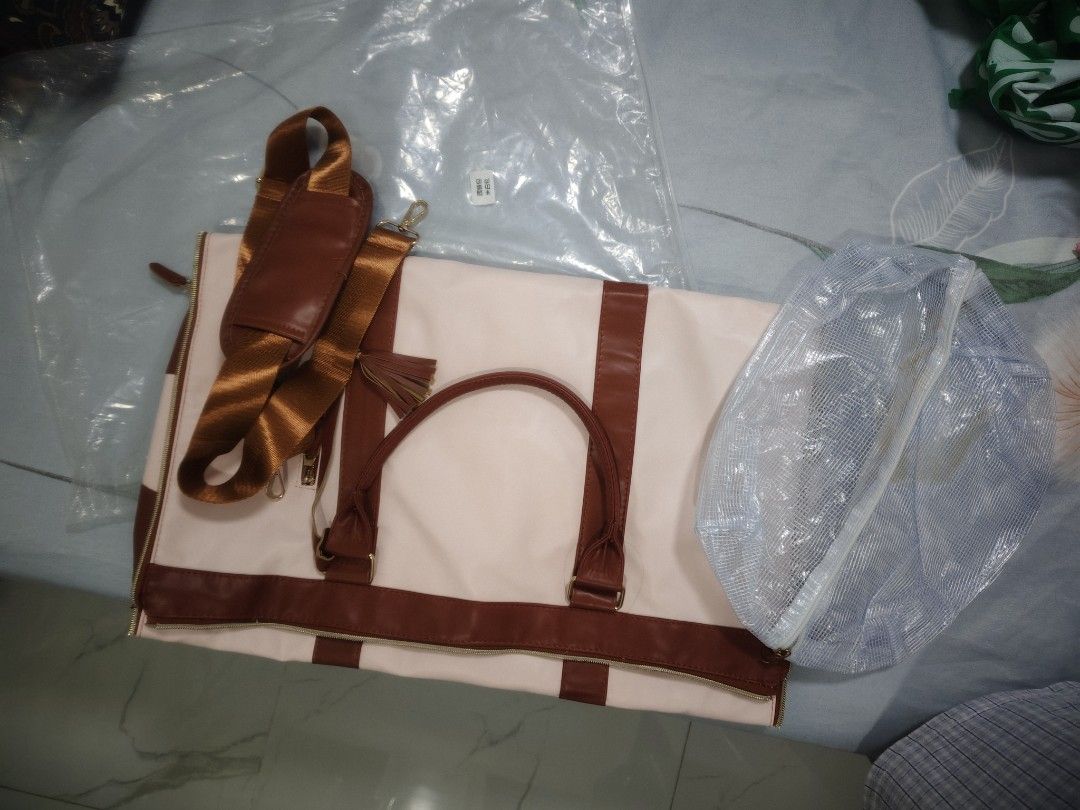 Canvas & Leather Duffle Bag with Garment Bag (Category: Tote Bags) located in Quezon City. Submitted by claudinen70390 (Listing ID 1460491739, Image 2). Description: - Stylish cream canvas duffle bag with elegant brown leather accents. - Ideal for weekend trips and travel. - Features a convenient separate garment bag that folds out. - Spacious dimensions: 52cm (L) x 25cm (W) x 32cm (H). - Versatile carrying options with a shoulder strap and top h