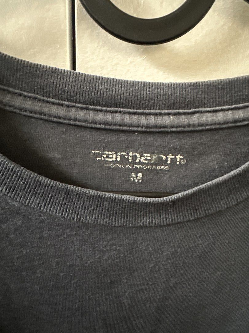 Carhartt Pocket T-Shirt (Category: Tshirts & Polo Shirts ) located in Mandaluyong City. Submitted by ayesesey (Listing ID 1460403392, Image 3). Description: - Classic Carhartt pocket tee - Color: Dark blue - Size: Medium (Oversized) - Simple and versatile for everyday wear - Perfect for layering or wearing on its own - Please check photos for detailed condition.