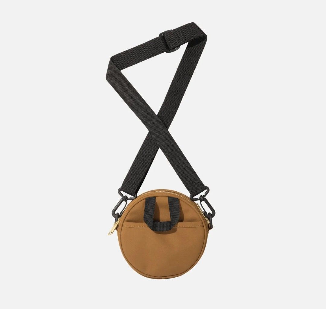 Carhartt W*I*P Clarton bag (Category: Sling Bags) located in Mariveles. Submitted by tams38 (Listing ID 1460431690, Image 2). Description: - Carhartt WIP round crossbody bag in tan - Main compartment with zipper closure - Small front pocket for quick access - Adjustable strap for a comfortable, customized fit - Features an embossed Carhartt logo on the front - Ideal for carrying your dailyessentialsK -Kasya Passport -From Germany -Estimated deliv
