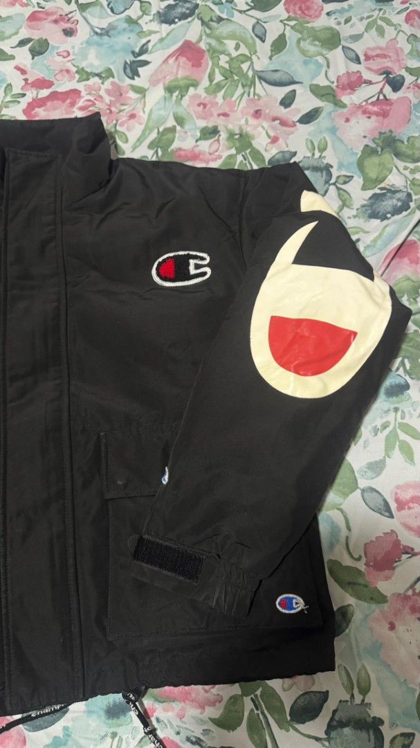 Champion Black Jacket with Large Logo on Sleeve (Category: Coats, Jackets and Outerwear) located in Cagayan de Oro. Submitted by moisthename_ (Listing ID 1460355479, Image 2). Description: - Classic black Champion jacket - Iconic Champion logo on sleeve - Adjustable velcro cuffs - Two front pockets with velcro closure - Drawstring hem for a customizable fit - Ideal for everyday casual wear.