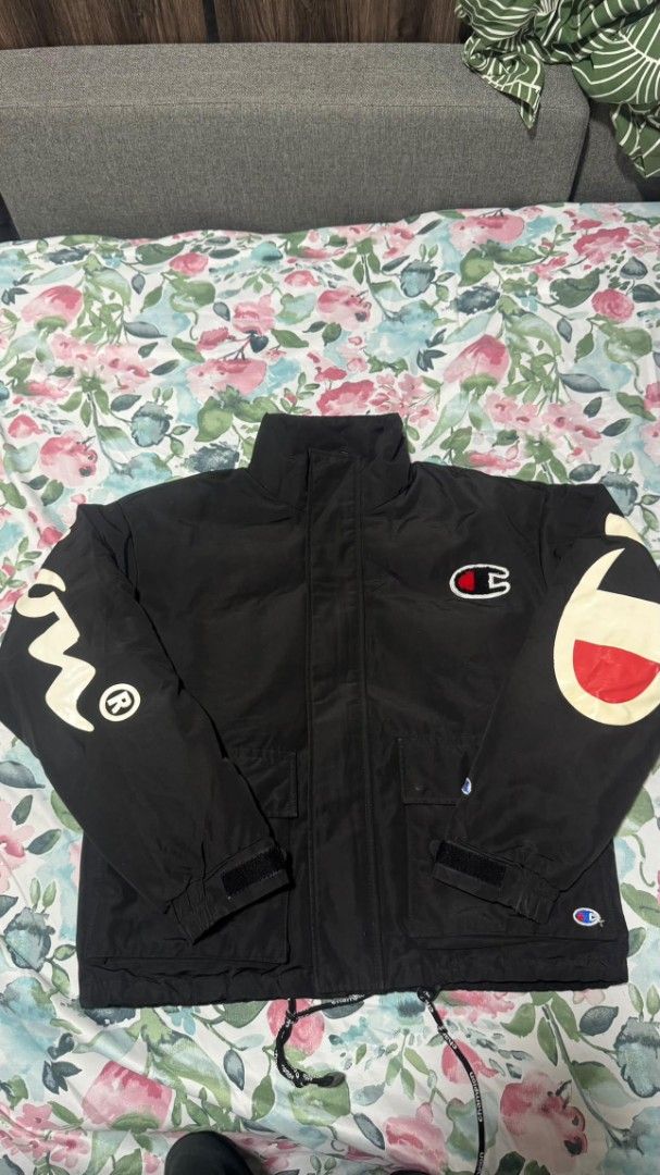 Champion Black Jacket with Large Logo on Sleeve (Category: Coats, Jackets and Outerwear) located in Cagayan de Oro. Submitted by moisthename_ (Listing ID 1460355479, Image 1). Description: - Classic black Champion jacket - Iconic Champion logo on sleeve - Adjustable velcro cuffs - Two front pockets with velcro closure - Drawstring hem for a customizable fit - Ideal for everyday casual wear.