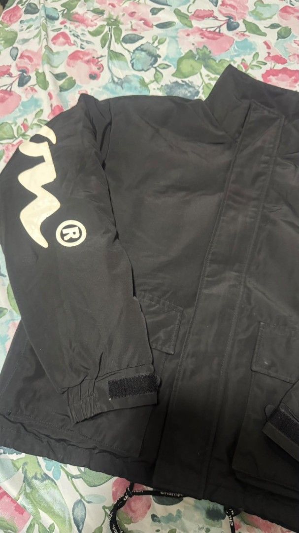 Champion Black Jacket with Large Logo on Sleeve (Category: Coats, Jackets and Outerwear) located in Cagayan de Oro. Submitted by moisthename_ (Listing ID 1460355479, Image 3). Description: - Classic black Champion jacket - Iconic Champion logo on sleeve - Adjustable velcro cuffs - Two front pockets with velcro closure - Drawstring hem for a customizable fit - Ideal for everyday casual wear.