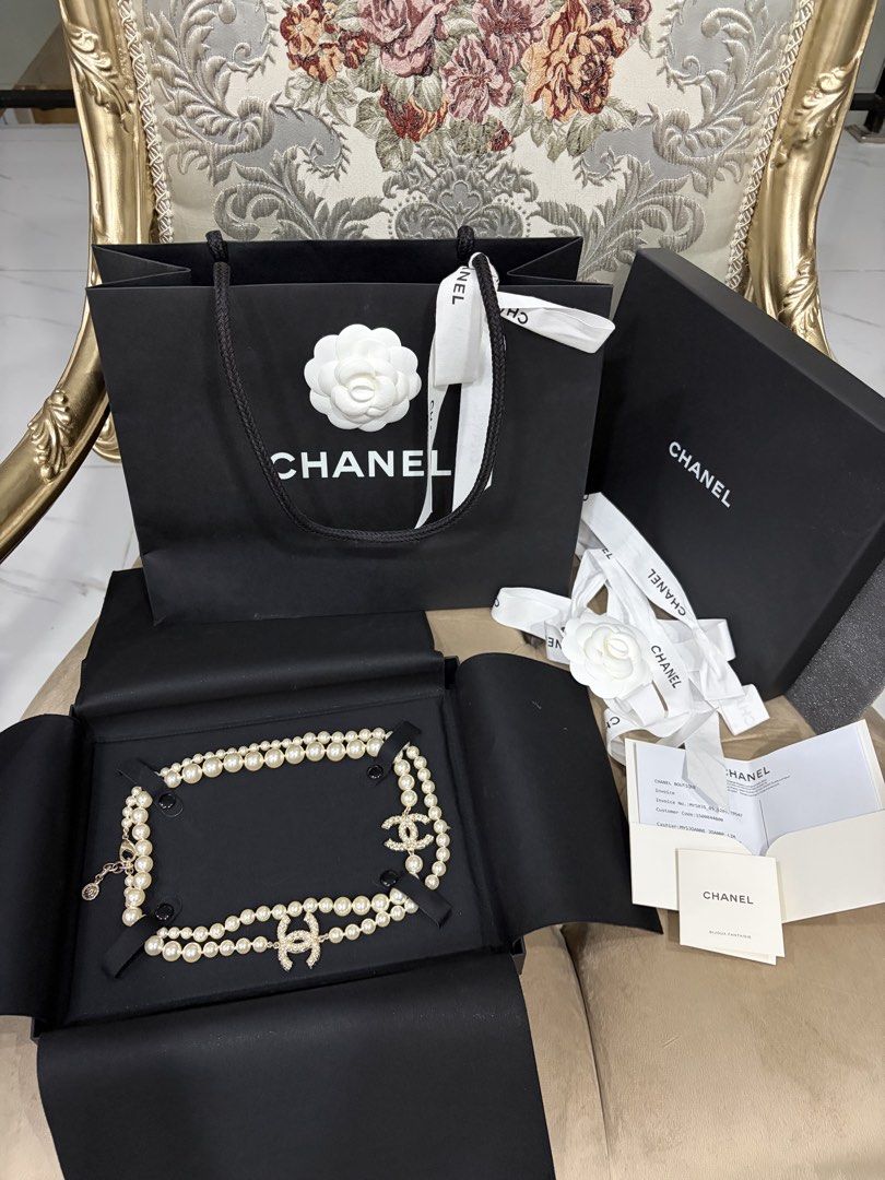 Chanel Pearl Necklace with CC Logo (Category: Necklaces) located in Rosales. Submitted by mcosue1. (Listing ID 1460451608, Image 1). Description: - Authentic Chanel double strand pearl necklace - Features iconic Chanel CC logo with crystal embellishments - Comes with original Chanel box, shopping bag, ribbon, and camellia flower - Includes authenticity cards - Purchased directly from a Chanel boutique w/ receipt Hard to Find chanel pearl necklace