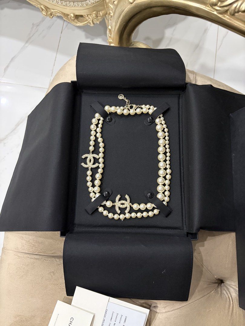 Chanel Pearl Necklace with CC Logo (Category: Necklaces) located in Rosales. Submitted by mcosue1. (Listing ID 1460451608, Image 3). Description: - Authentic Chanel double strand pearl necklace - Features iconic Chanel CC logo with crystal embellishments - Comes with original Chanel box, shopping bag, ribbon, and camellia flower - Includes authenticity cards - Purchased directly from a Chanel boutique w/ receipt Hard to Find chanel pearl necklace
