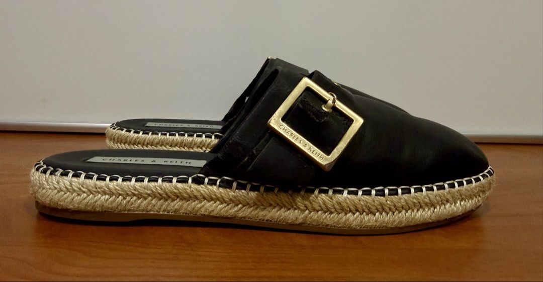 Charles & Keith Black Espadrille Mules (Category: Slippers and slides) located in Binangonan. Submitted by c_r_i_s (Listing ID 1460463911, Image 1). Description: Charles & Keith Black Espadrille Mules Women’s Size 38 and may fit Size 37 Stylish black slip-on mules featuring oversized gold-tone buckles and woven espadrille platform soles. Comfortable, versatile, and easy to pair with casual or smart-casual outfits. * Size: EU 38 * Color: Black * B