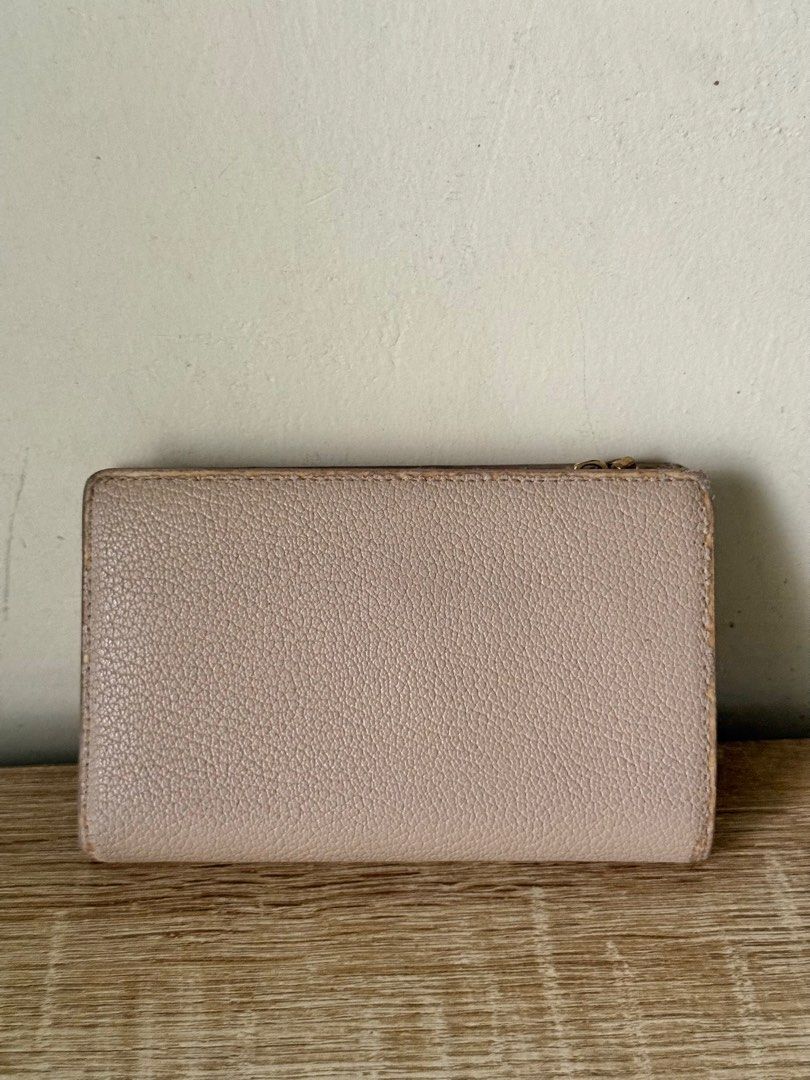 Charles & Keith Nude Wallet (Category: Wallets & Card holders) located in Caloocan City. Submitted by _declutterbym (Listing ID 1460435997, Image 2). Description: - Brand: Charles & Keith - Color: Beige/Nude - Design: Tri-fold - Features: Multiple card slots, zip compartment for coins/cash - Size: Small and compact, fits easily in any bag - Ideal for: Everyday use, keeping essentials organized.