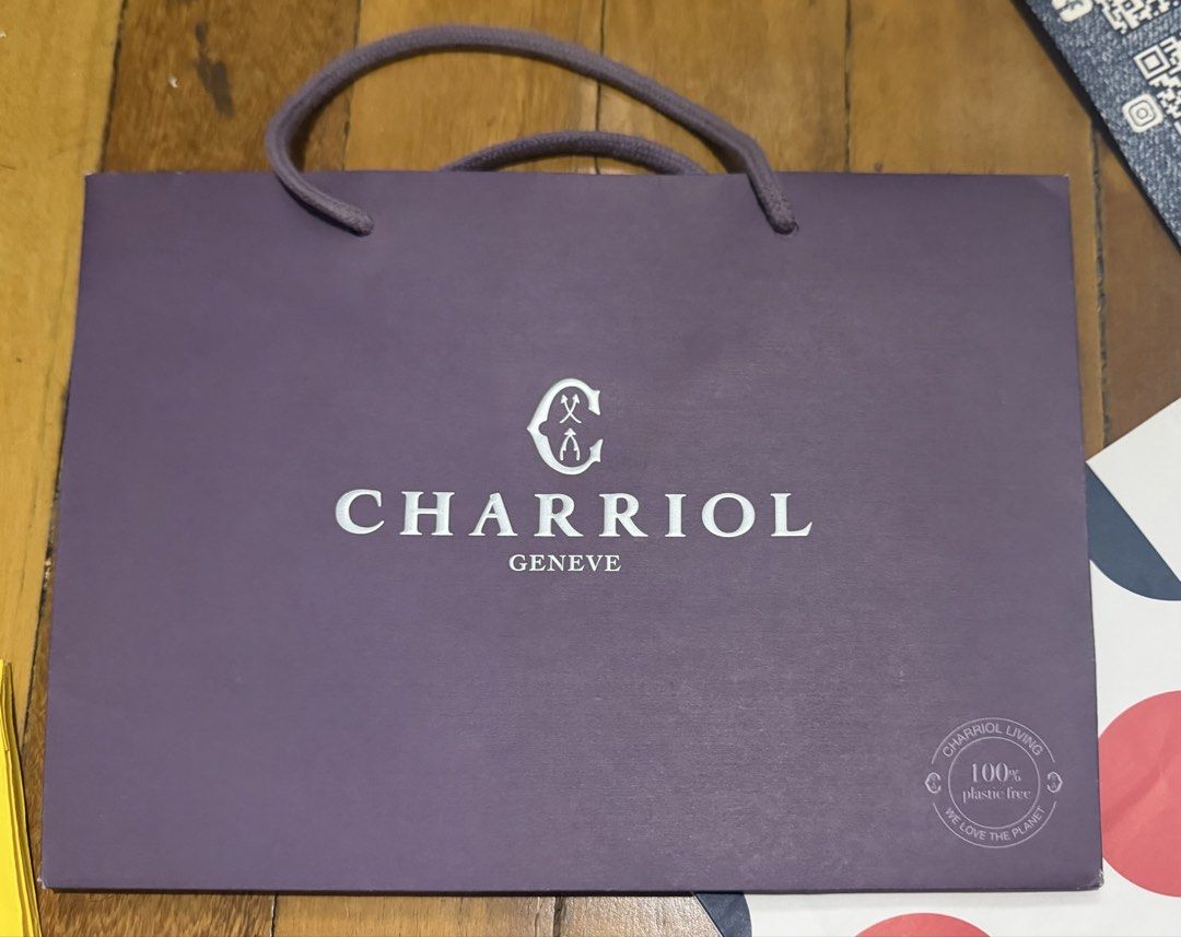 Charriol Geneve Shopping Bag (Category: Luxury Bags & Wallets) located in Paranaque City. Submitted by crew08 (Listing ID 1460307210, Image 2). Description: - Authentic Charriol Geneve paper bag - Color: Purple - brand new, No creases no stains - Charriol logo and 'Art de Vivre la Différence' detail -lxwxh (9x12.5x4.5 in inches) - Ideal as a gift bag.