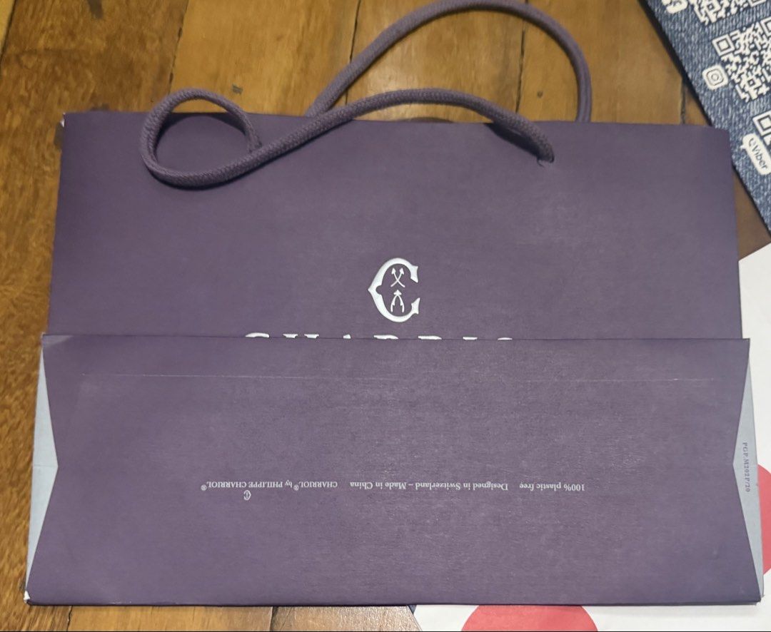 Charriol Geneve Shopping Bag (Category: Luxury Bags & Wallets) located in Paranaque City. Submitted by crew08 (Listing ID 1460307210, Image 3). Description: - Authentic Charriol Geneve paper bag - Color: Purple - brand new, No creases no stains - Charriol logo and 'Art de Vivre la Différence' detail -lxwxh (9x12.5x4.5 in inches) - Ideal as a gift bag.