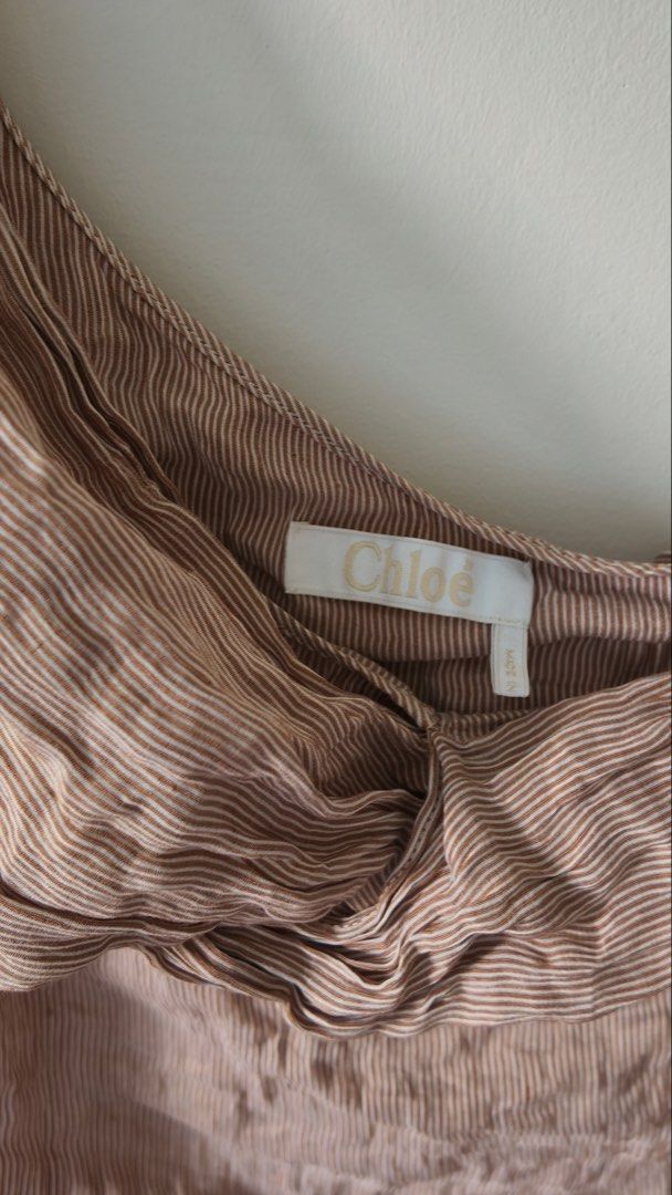 Chloe One Shoulder Ruched Striped Top (Category: Blouses) located in Pasig City. Submitted by prelovedbyfashionista (Listing ID 1460450100, Image 2). Description: - Trendy brown and white striped pattern - Stylish one-shoulder design - Flattering ruched detailing - Lightweight fabric for comfort - Estimated size: Small - Versatile for casual outings or evening events - SRP: 60k++.