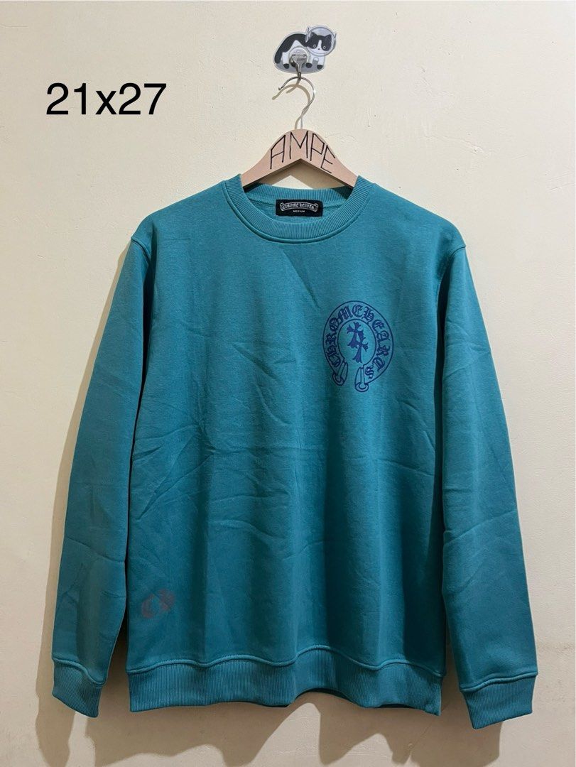 Chrome Hearts Horseshoe Logo Sweatshirt Teal Medium (Category: Coats, Jackets and Outerwear) located in Manila. Submitted by juspheroca82034 (Listing ID 1460388861, Image 1). Description: - Teal Chrome Hearts sweatshirt - Size: Medium - Front: Horseshoe logo - Back: Double crosses - Left Sleeve: Small Chrome Hearts logo - Measurements: 21" pit to pit, 27" length.