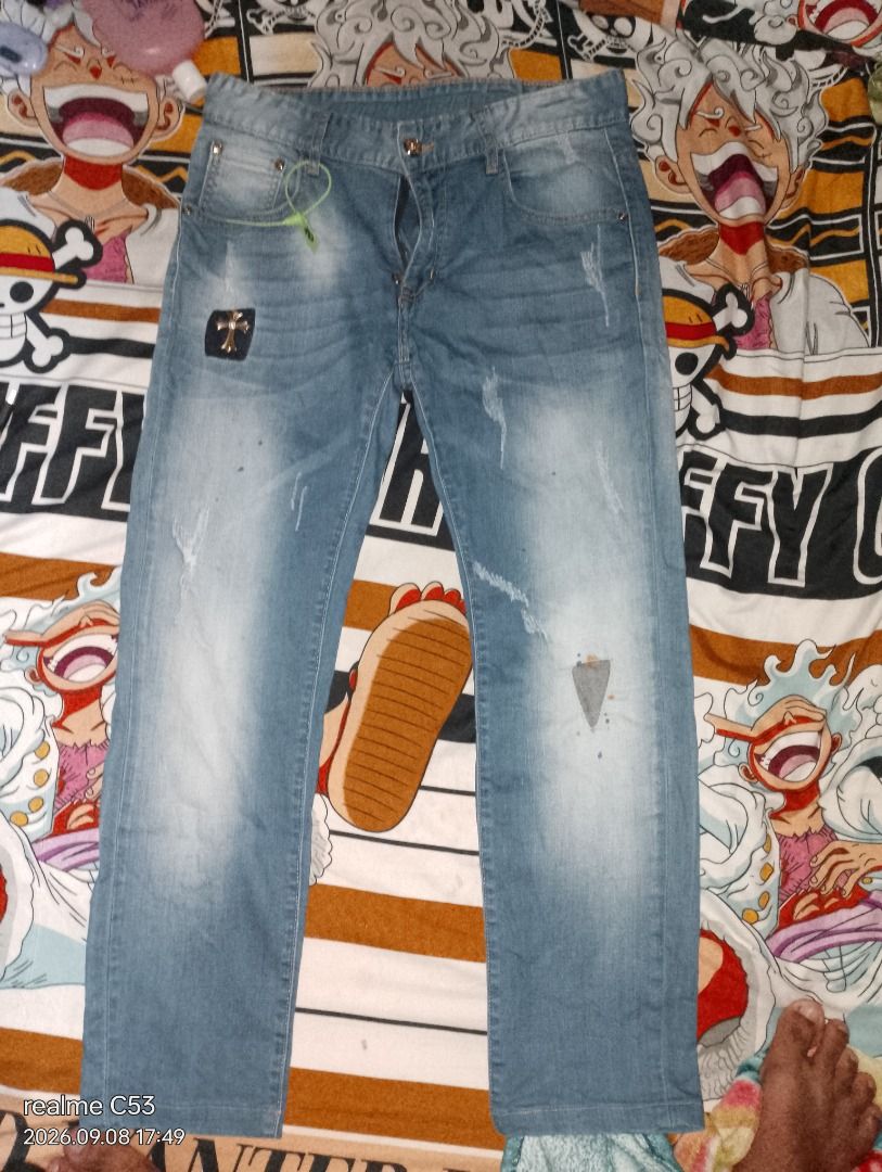 Chrome Hearts Style Denim Jeans (Category: Jeans) located in San Jose. Submitted by aickozero314322 (Listing ID 1460461774, Image 3). Description: - Light wash denim jeans - Distressed details and patches for a unique look - Eye-catching cross embellishments on the waistband - Classic straight leg fit - Ideal for everyday casual wear.