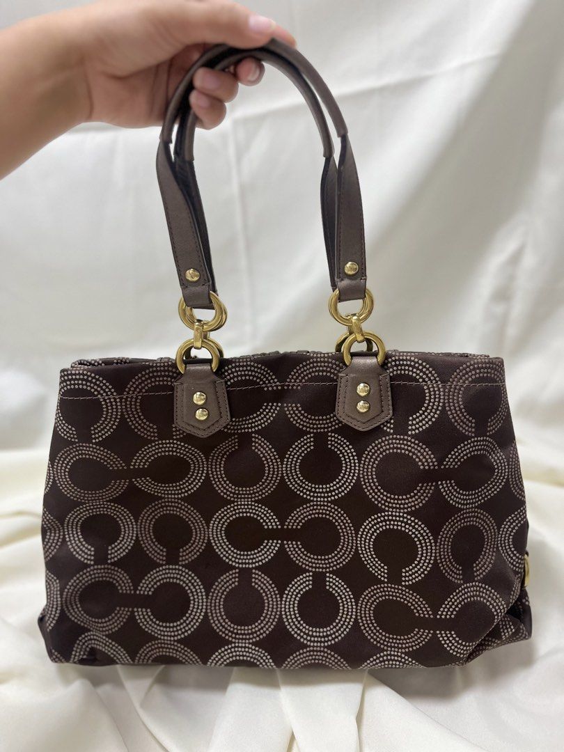 Coach Ashley Choco Brown (Category: Luxury Bags & Wallets) located in Quezon. Submitted by consulhann69386 (Listing ID 1460356699, Image 2). Description: - Authentic Coach tote bag - Signature C monogram pattern - Rich brown leather trim - Elegant gold hardware - Vibrant pink interior lining - Convenient interior zippered compartment - Ample space for all your essentials - Perfect for everyday errands or a stylish night out.