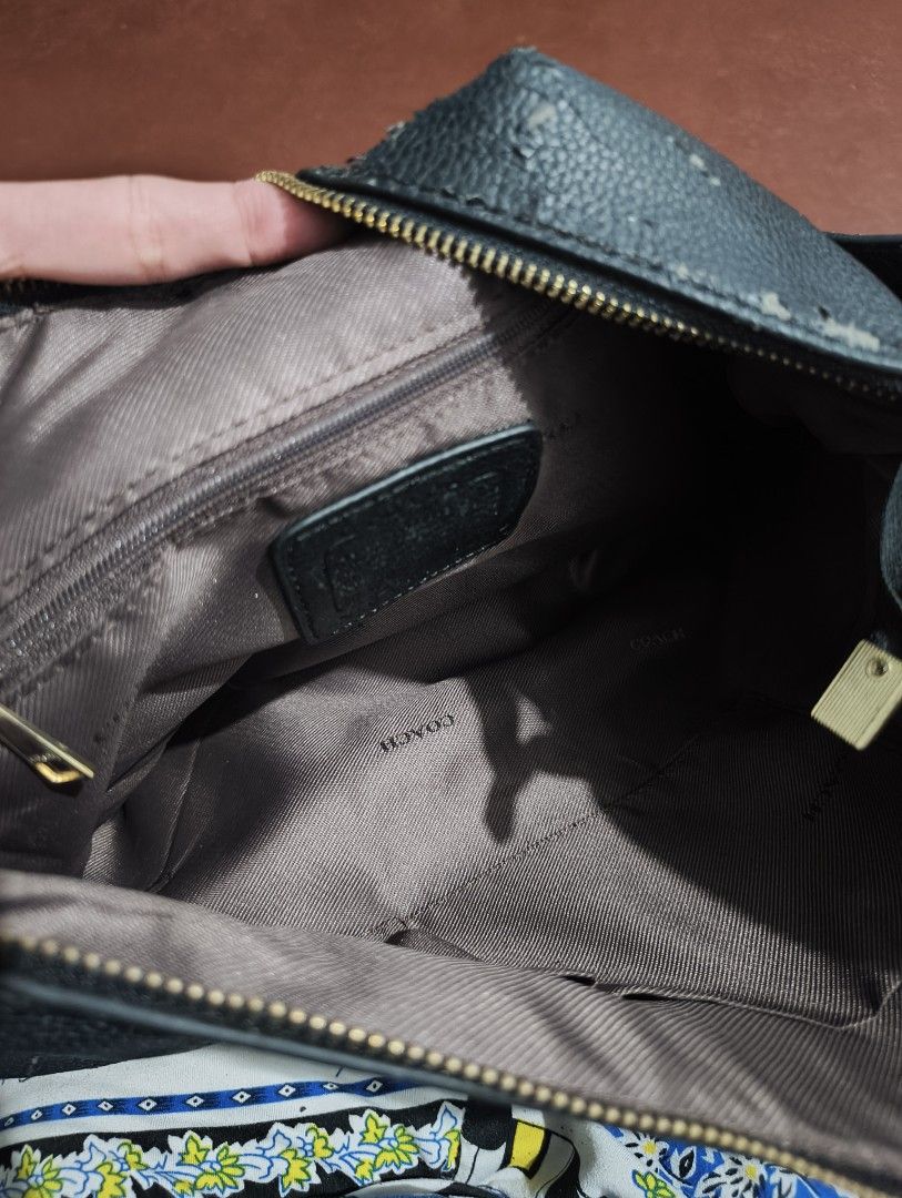 Coach Black Leather Hobo Shoulder Bag (Category: Shoulder Bags) located in Manila. Submitted by marjdv29 (Listing ID 1460363879, Image 2). Description: - Authentic black leather Coach hobo bag - Secure zipper closure - Interior features signature Coach logo lining - Perfect for everyday use issue bakbak. baka may magkagusto pa at ipaayos. ang mahal ng coach! orig to, bnew sana kaso na stock at nainitan di nagamit kaya ganyan.