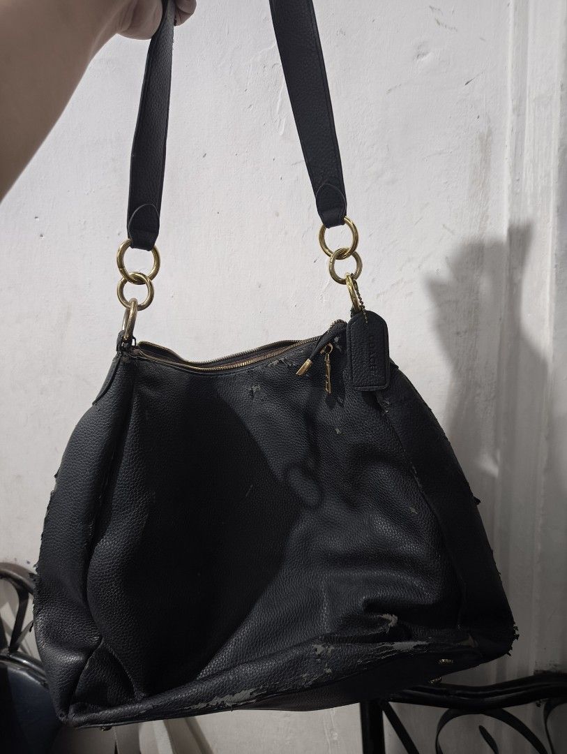 Coach Black Leather Hobo Shoulder Bag (Category: Shoulder Bags) located in Manila. Submitted by marjdv29 (Listing ID 1460363879, Image 1). Description: - Authentic black leather Coach hobo bag - Secure zipper closure - Interior features signature Coach logo lining - Perfect for everyday use issue bakbak. baka may magkagusto pa at ipaayos. ang mahal ng coach! orig to, bnew sana kaso na stock at nainitan di nagamit kaya ganyan.