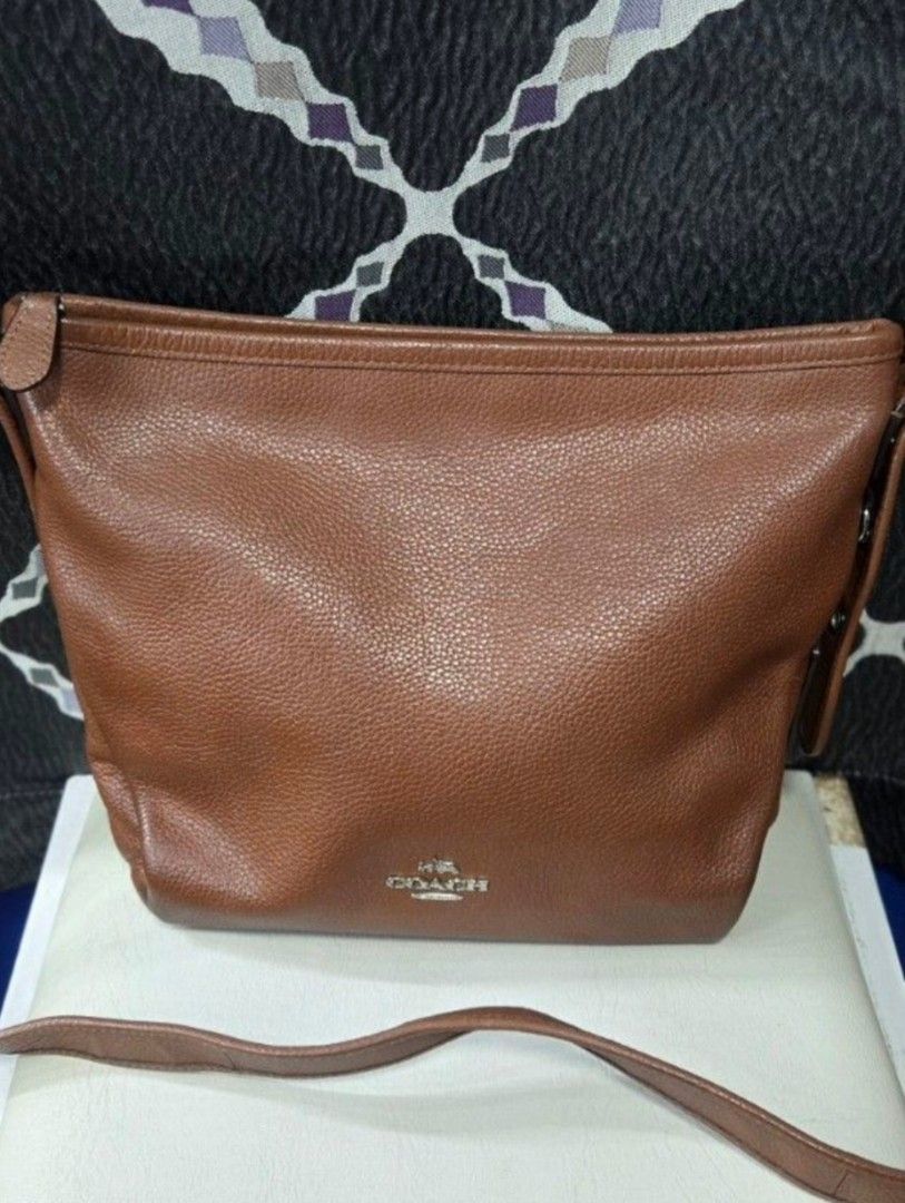Coach Brown Leather Shoulder Bag (Category: Luxury Bags & Wallets) located in Quezon City. Submitted by affordabags_cd (Listing ID 1460422529, Image 1). Description: - Brand: Coach - Material: Brown pebbled leather - Closure: Zip top - Interior: Fabric lining with Coach branding patch - Origin: Made in Vietnam - Style: Great everyday shoulder bag.