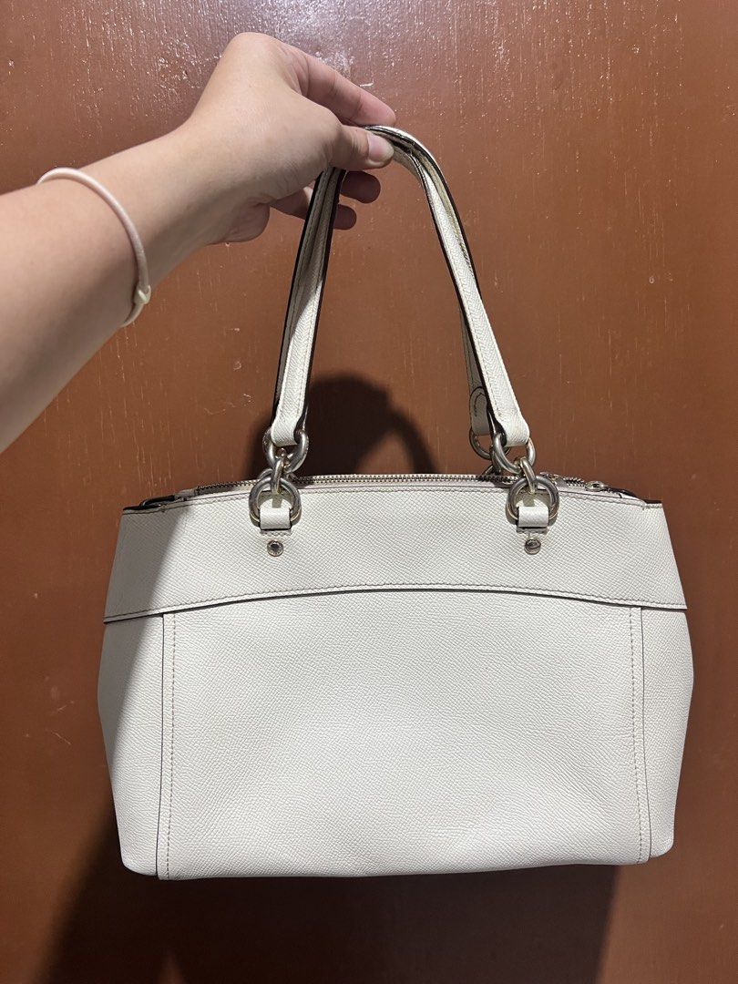 Coach Christie Carryall with strap (Category: Luxury Bags & Wallets) located in Binan City. Submitted by closet_in_disguise (Listing ID 1460329424, Image 2). Description: - Authentic Coach white leather tote bag - Secure zip closure at the top - Comfortable dual handles for carrying - Iconic Coach hang tag included - Ample interior space for all your essentials - Ideal for everyday use and versatile styling.