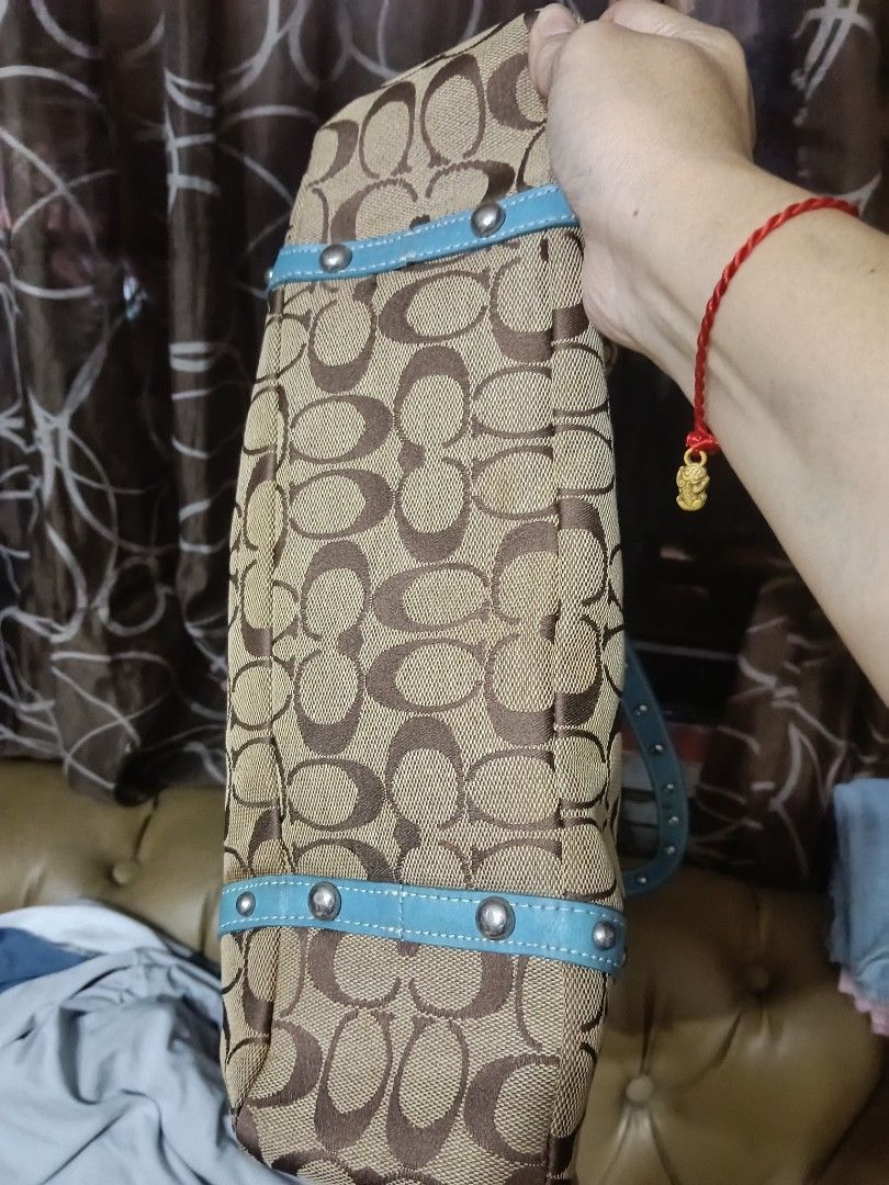 Coach Monogram Canvas & Leather Trim Tote Bag (Category: Luxury Bags & Wallets) located in Quezon City. Submitted by bshoppe_ (Listing ID 1460423425, Image 3). Description: - Authentic Coach monogram canvas tote in brown and tan. - Stylish light blue leather trim and handles with decorative stud details. - Secure clip closure to keep your belongings safe. - Interior zippered pocket for organizing essentials. - Ample space, making it an ideal ever