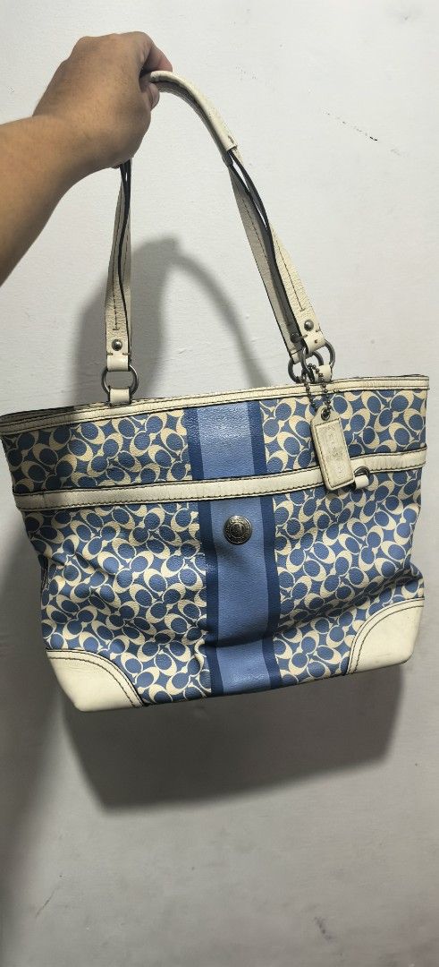 Coach Monogram Canvas & Leather Tote Bag (Category: Luxury Bags & Wallets) located in Abucay. Submitted by jerlynbal98316 (Listing ID 1460466132, Image 1). Description: - Classic Coach tote bag - Signature blue and cream monogram pattern - Genuine leather trim and handles - Stylish central stripe detail - Silver-tone hardware - Ample interior space for essentials - Ideal for everyday use.