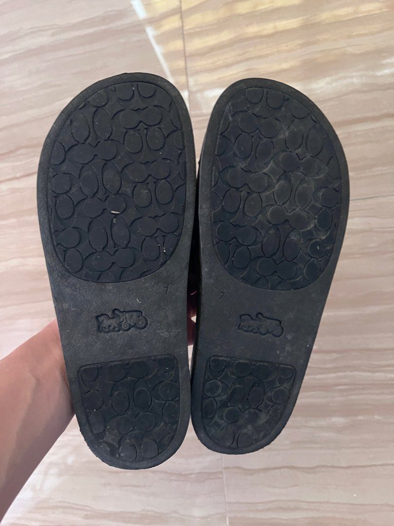 Coach Monogram Slides Sandals (Category: Slippers and slides) located in Malolos. Submitted by urgoodsfrommls (Listing ID 1460395617, Image 2). Description: - Authentic Coach monogram slides - Classic black footbed with white COACH lettering - Soles feature the signature Coach logo pattern - Size: 7 US / 38 EU - Ideal for casual wear and everyday comfort.