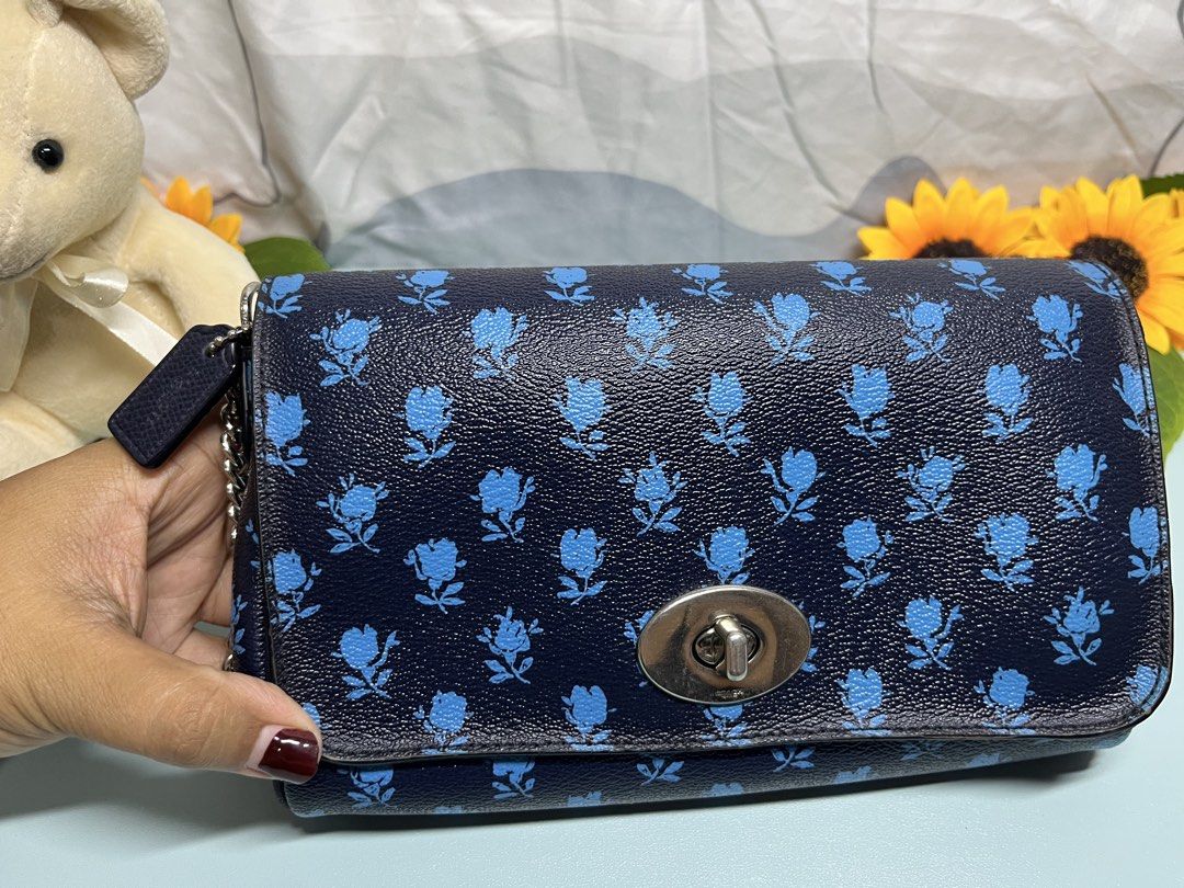 Coach Navy Blue Floral Print Shoulder Bag (Category: Luxury Bags & Wallets) located in Liloan. Submitted by sakurumifinds2809 (Listing ID 1460355111, Image 3). Description: - Navy blue shoulder bag - Cute blue floral print - Silver chain strap - Turn-lock closure - Interior pockets for essentials - Versatile and matches many outfits.