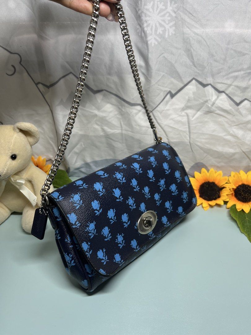 Coach Navy Blue Floral Print Shoulder Bag (Category: Luxury Bags & Wallets) located in Liloan. Submitted by sakurumifinds2809 (Listing ID 1460355111, Image 2). Description: - Navy blue shoulder bag - Cute blue floral print - Silver chain strap - Turn-lock closure - Interior pockets for essentials - Versatile and matches many outfits.