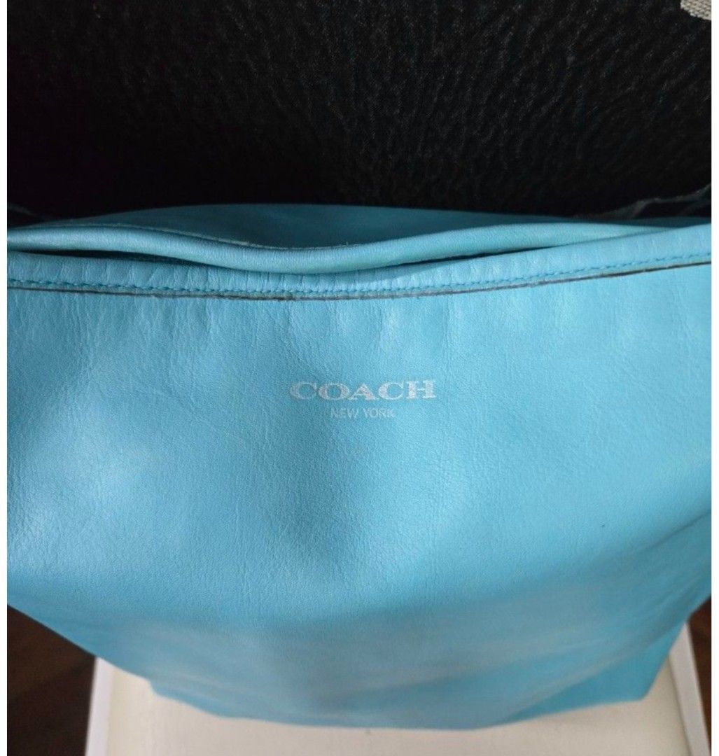 Coach New York Leather Shoulder Bag (Category: Luxury Bags & Wallets) located in Quezon City. Submitted by affordabags_cd (Listing ID 1460422926, Image 2). Description: - Light blue Coach shoulder bag - Front zip pocket - Side tassel detail - Embossed Coach New York logo on front - Spacious interior - Ideal for everyday use.