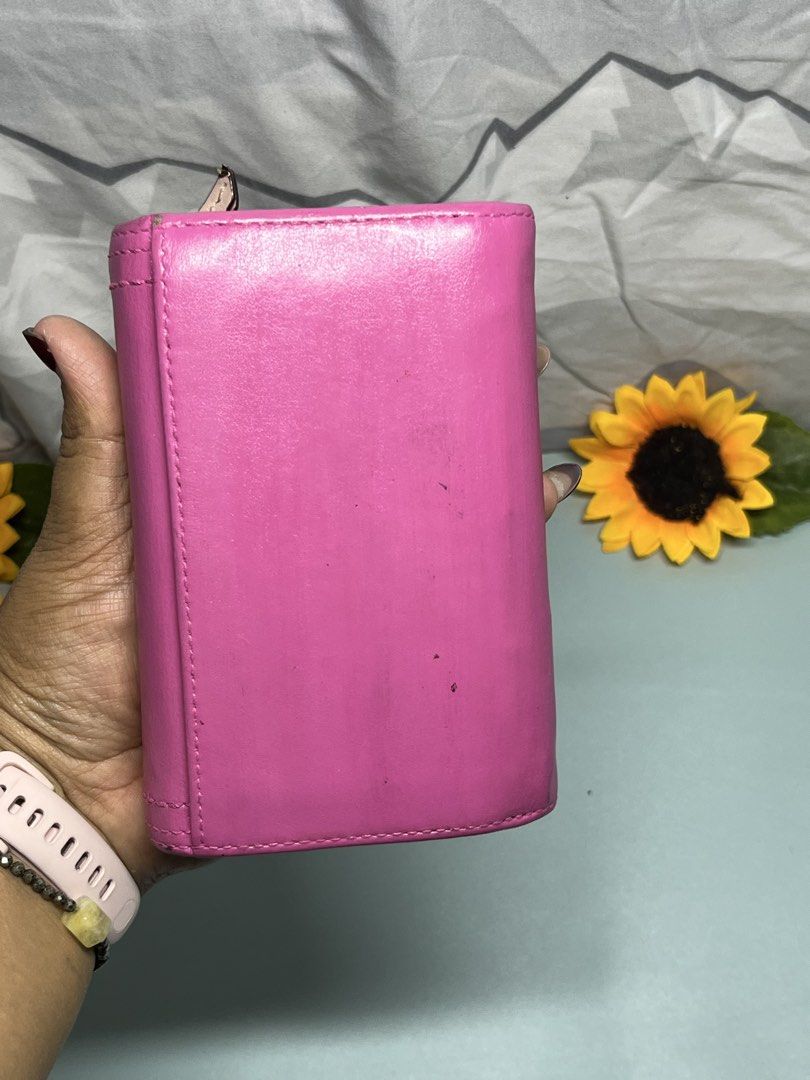 Coach Pink Leather Bifold Wallet (Category: Wallets & Card holders) located in Liloan. Submitted by sakurumifinds2809 (Listing ID 1460359674, Image 3). Description: - Brand: Coach - Color: Pink - Style: Trifold Wallet - Material: Leather - Closure: Buckle on front - Interior: Card slots and zippered compartment - Condition: Shows some signs of wear on exterior, still functional and cute, repainted .