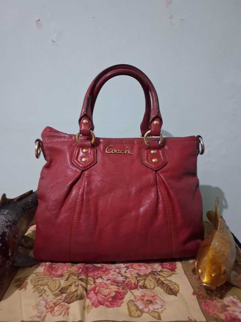 Coach Red Leather Satchel Handbag (Category: Luxury Bags & Wallets) located in Hinigaran. Submitted by faye_fab (Listing ID 1460504816, Image 1). Description: - Classic red Coach leather satchel - Signature 'Coach' logo embossed on front - Gold-tone hardware accents - Top handles for carrying - Spacious interior for essentials - Ideal everyday bag.
